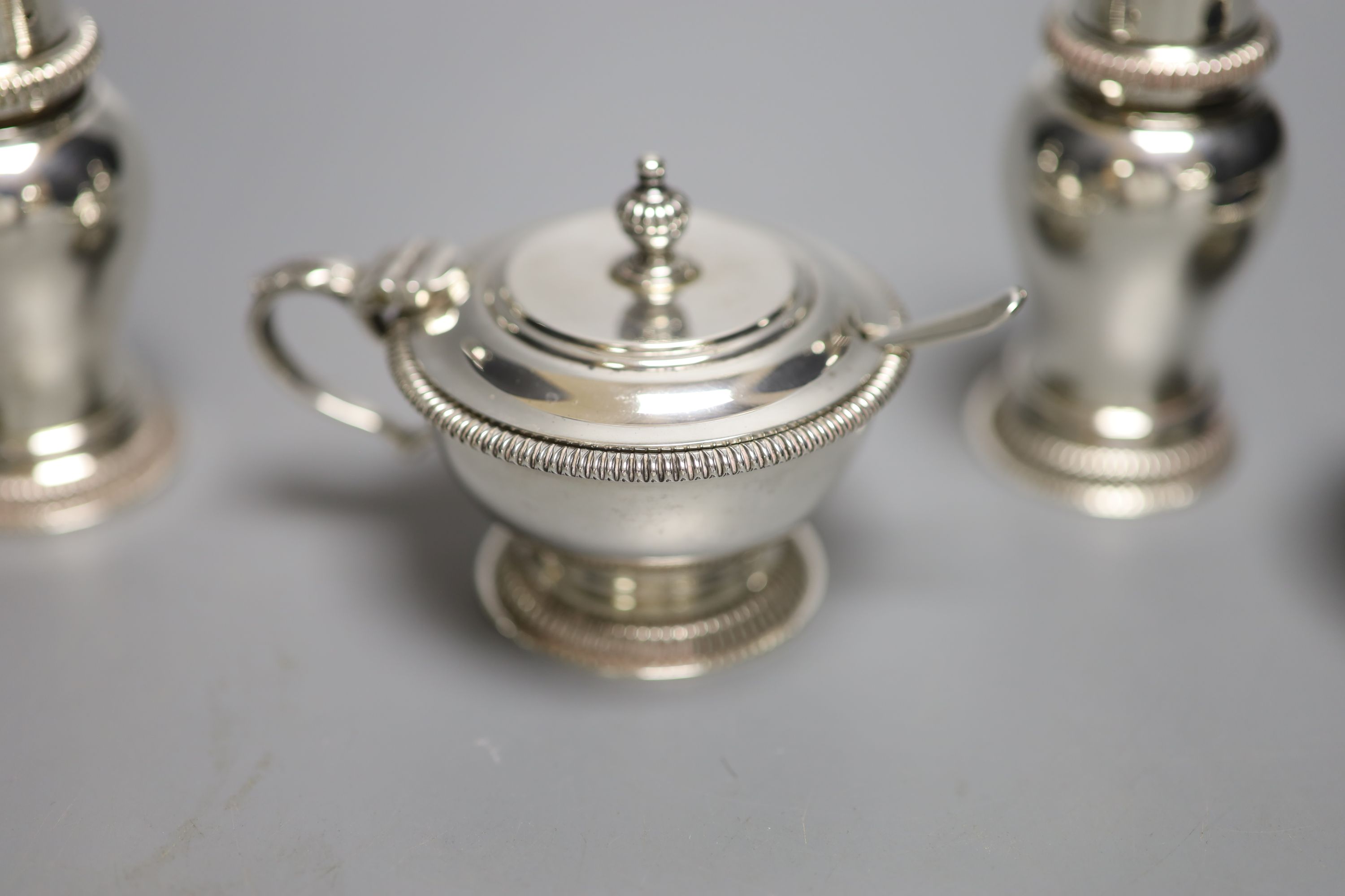 A modern silver five piece condiment set including one spoon, by William Comyns & Sons Ltd, London, 1960 & 1967,